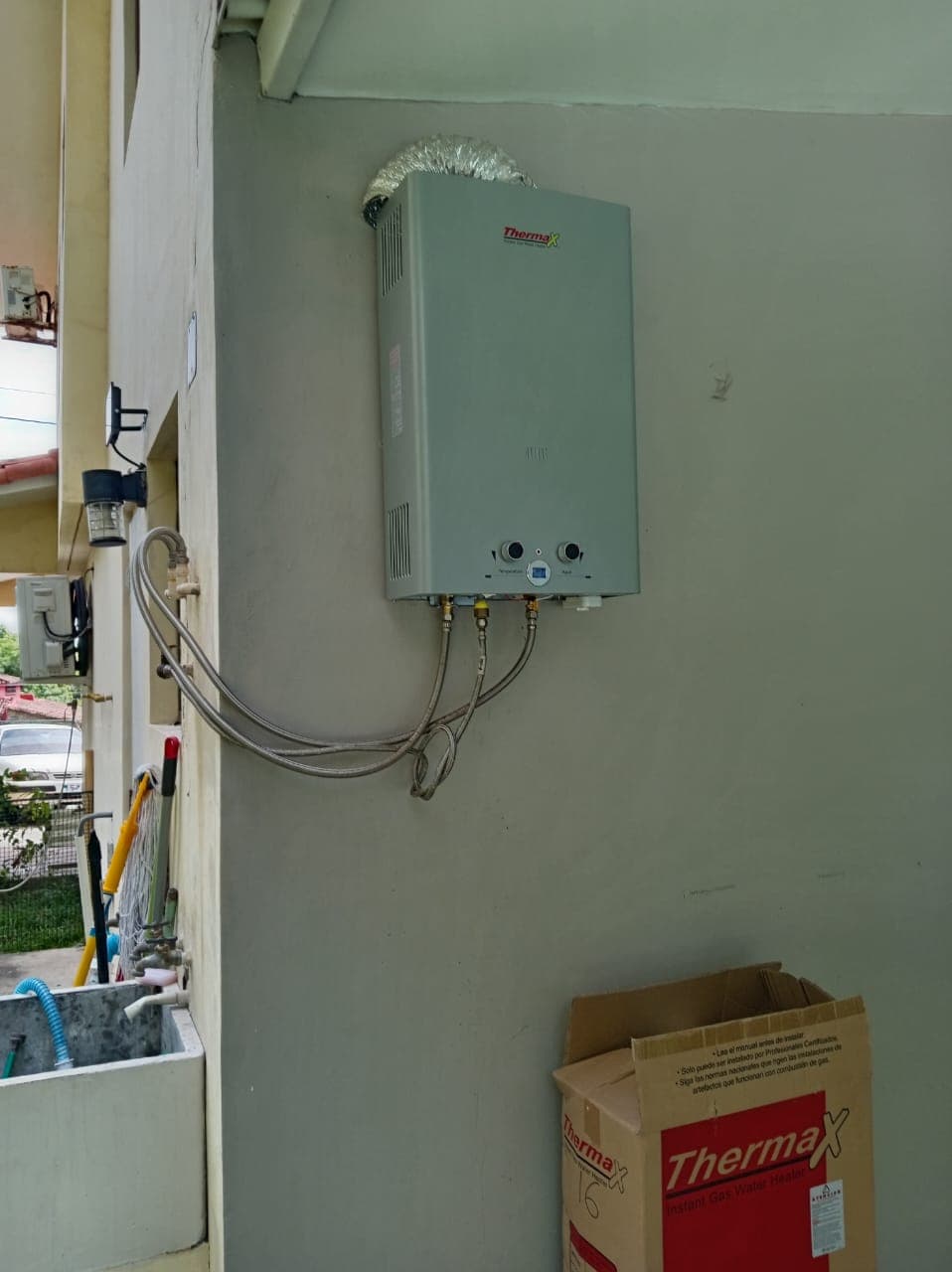 After: the new gas water heater installed on the exterior wall